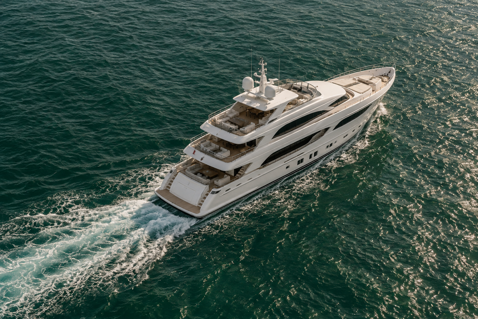 Illustrative aerial view of a large motor yacht moving through deep green water